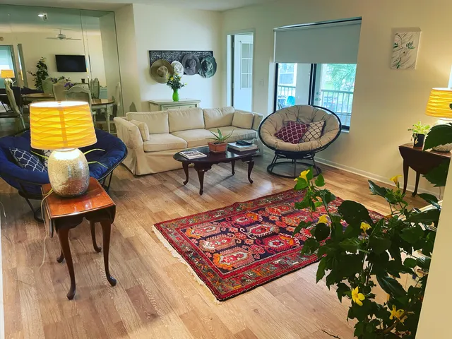 a living room with furniture and a wooden floor
