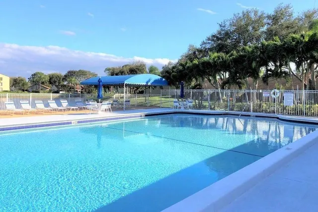 a view of a swimming pool with outdoor seating
