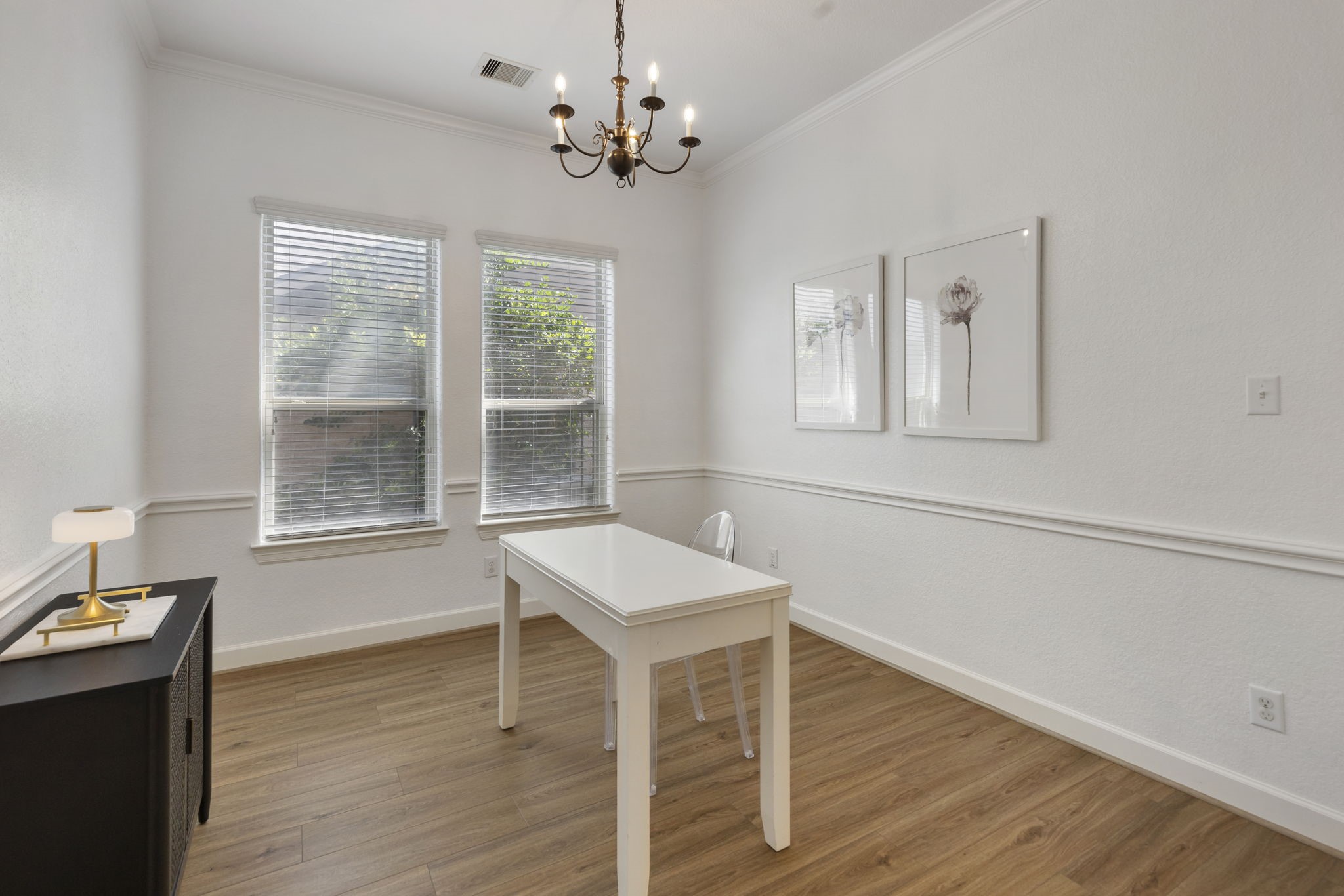 71 Sagamore Ridge Place The Woodlands, TX 77389 - Photo 8 of 34 a view of a room with wooden floor windows and chandelier