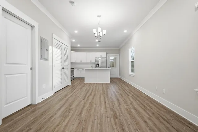 a view of a kitchen with wooden floor and a kitchen