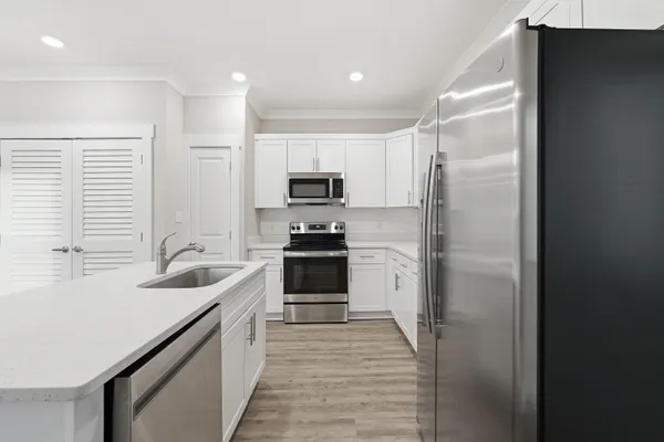 a kitchen with a sink stove and refrigerator
