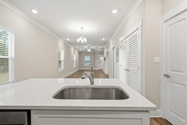 a kitchen with a sink and chandelier