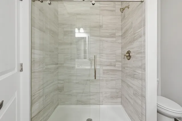 a bathroom with a shower and a toilet