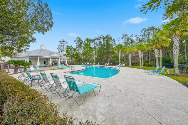 a view of a swimming pool with chairs in patio