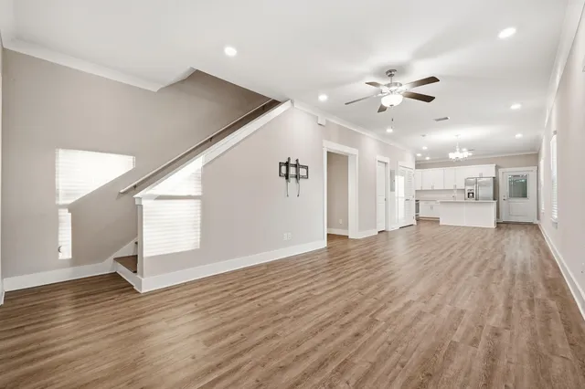 a view of an empty room and wooden floor