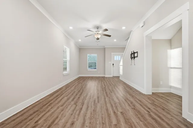 wooden floor in an empty room with a window