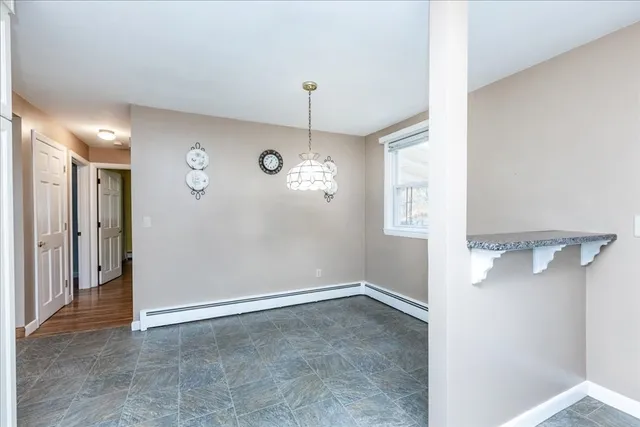 a view of a hallway with a chandelier fan and wooden floor