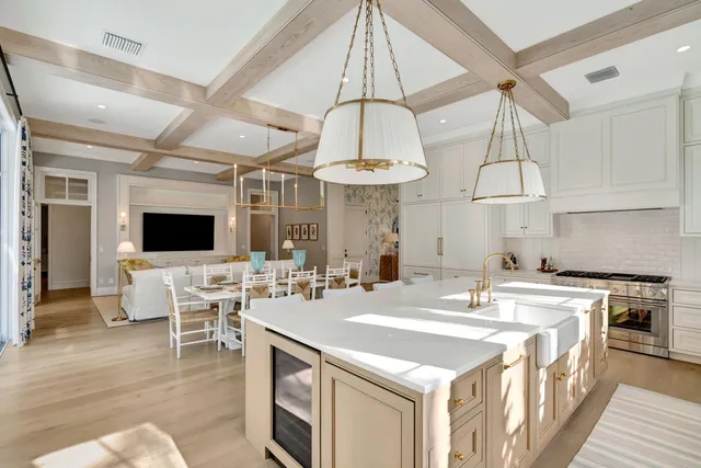 a kitchen with stainless steel appliances a table and chairs in it