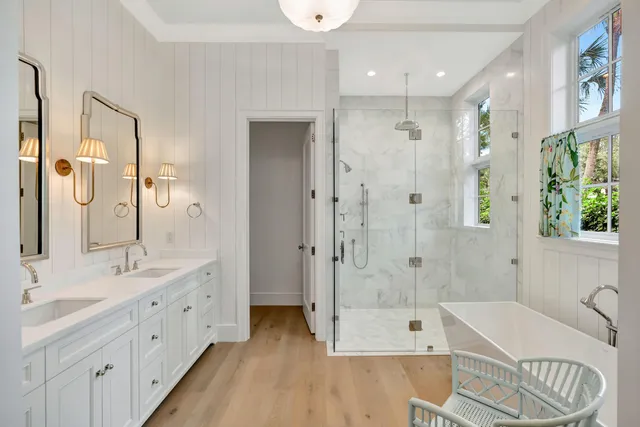 a spacious en suite bathroom with double sink and a large mirror