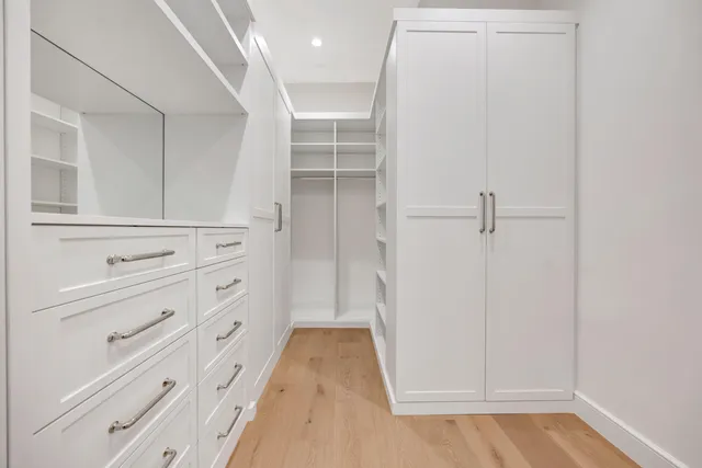 a bathroom with a double vanity sink toilet and shower