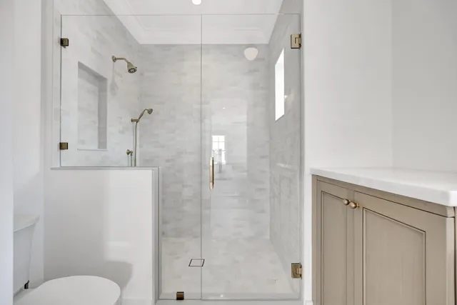 a bathroom with a toilet and a shower