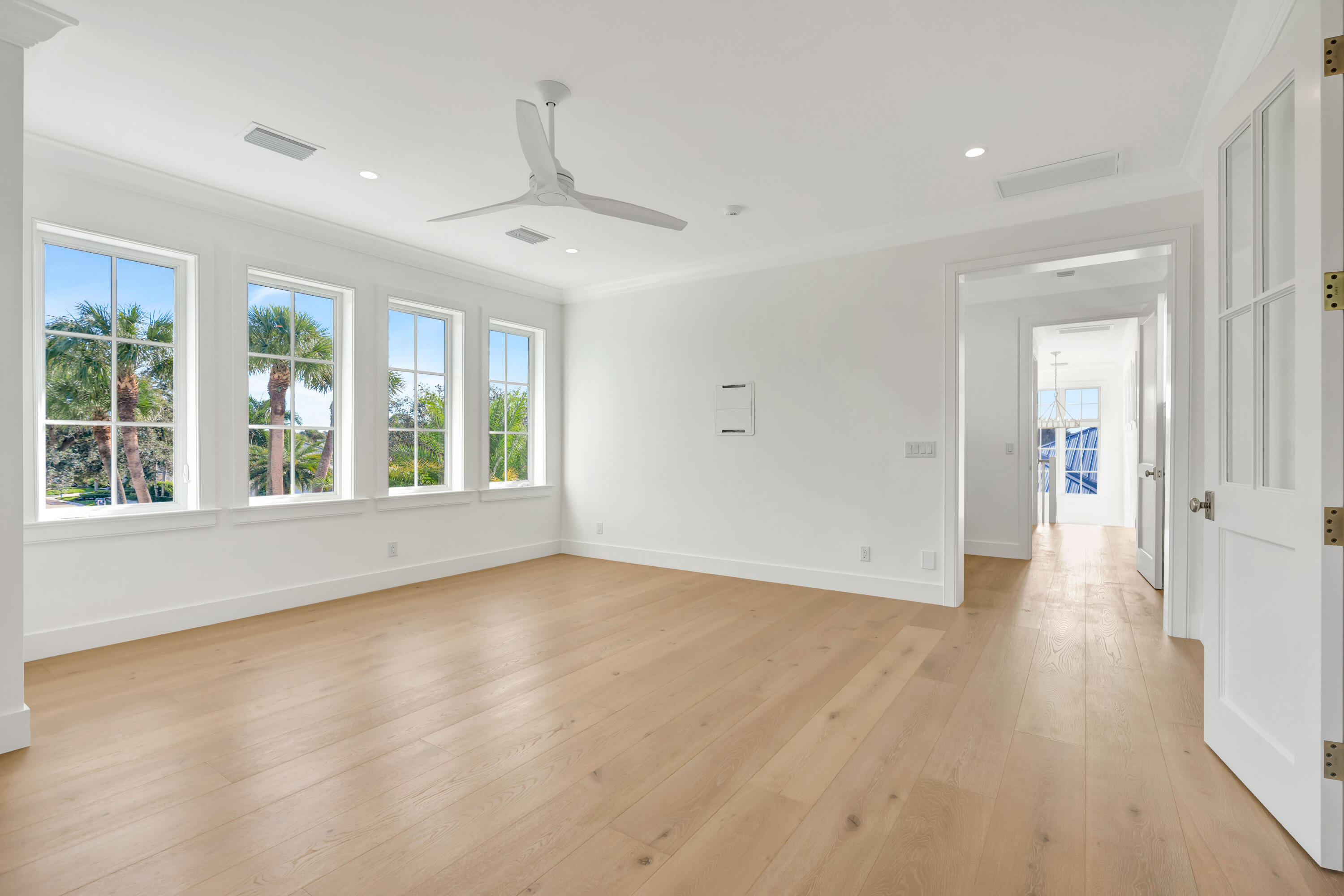185 Birkdale Lane Jupiter, FL 33458 - Photo 45 of 64 an empty room with wooden floor and windows