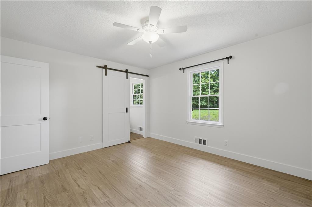 125 Childers Road Canton, GA 30115 - Photo 37 of 48 wooden floor in an empty room with a window