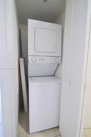 a view of a room with wooden floor and fan
