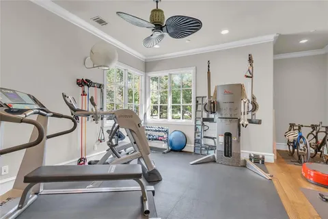 a backyard of a house with table and chairs under an umbrella