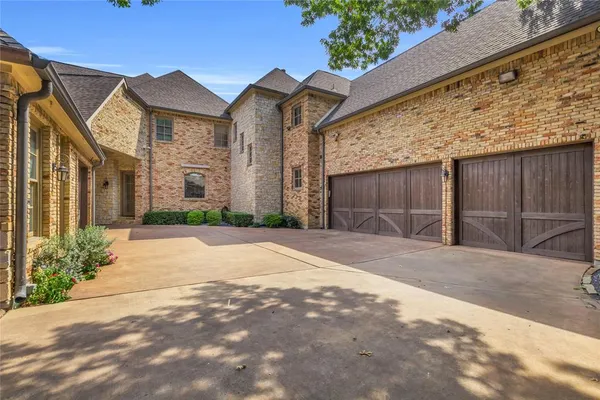 a front view of a house with a yard and a garage