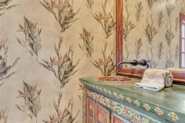 a living room with furniture a flat screen tv and a refrigerator