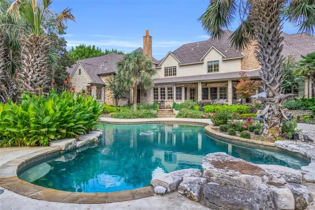 a view of a house with swimming pool and a garden