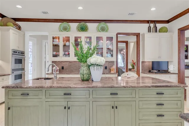 a dining room with furniture a chandelier and wooden floor