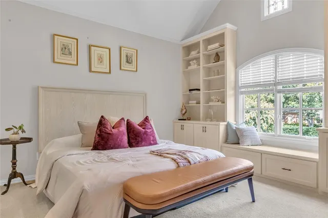 a view of a brick house with a flower garden