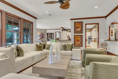 a living room with furniture and large windows