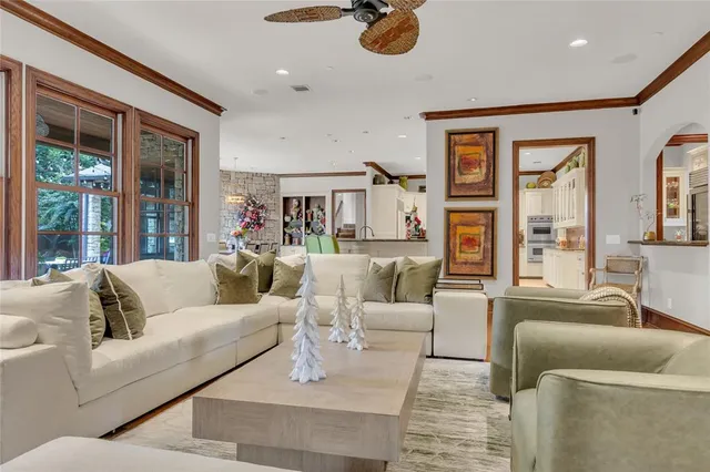 a living room with furniture and large windows