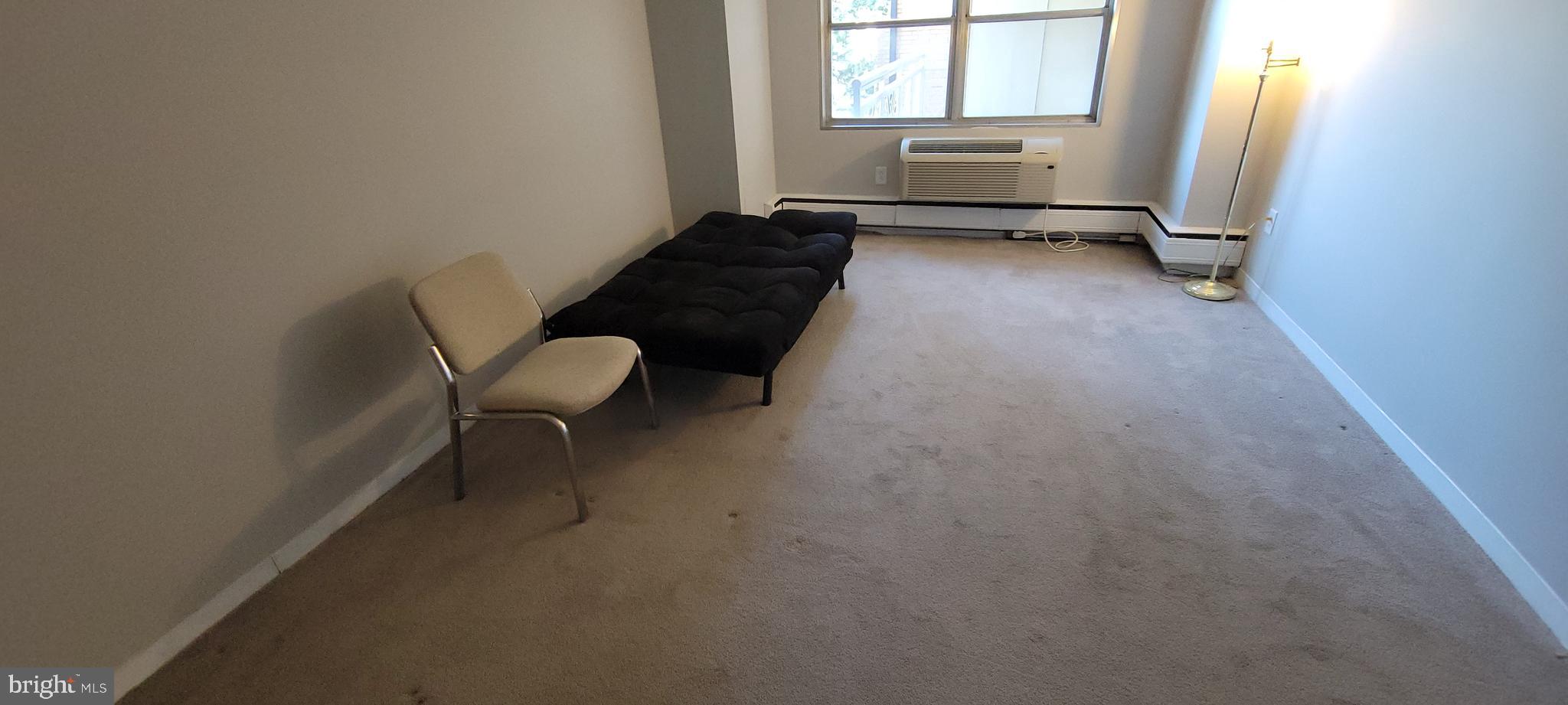7900 Old York Road, Unit 505A Elkins Park, PA 19027 - Photo 8 of 12 a living room with furniture and a window