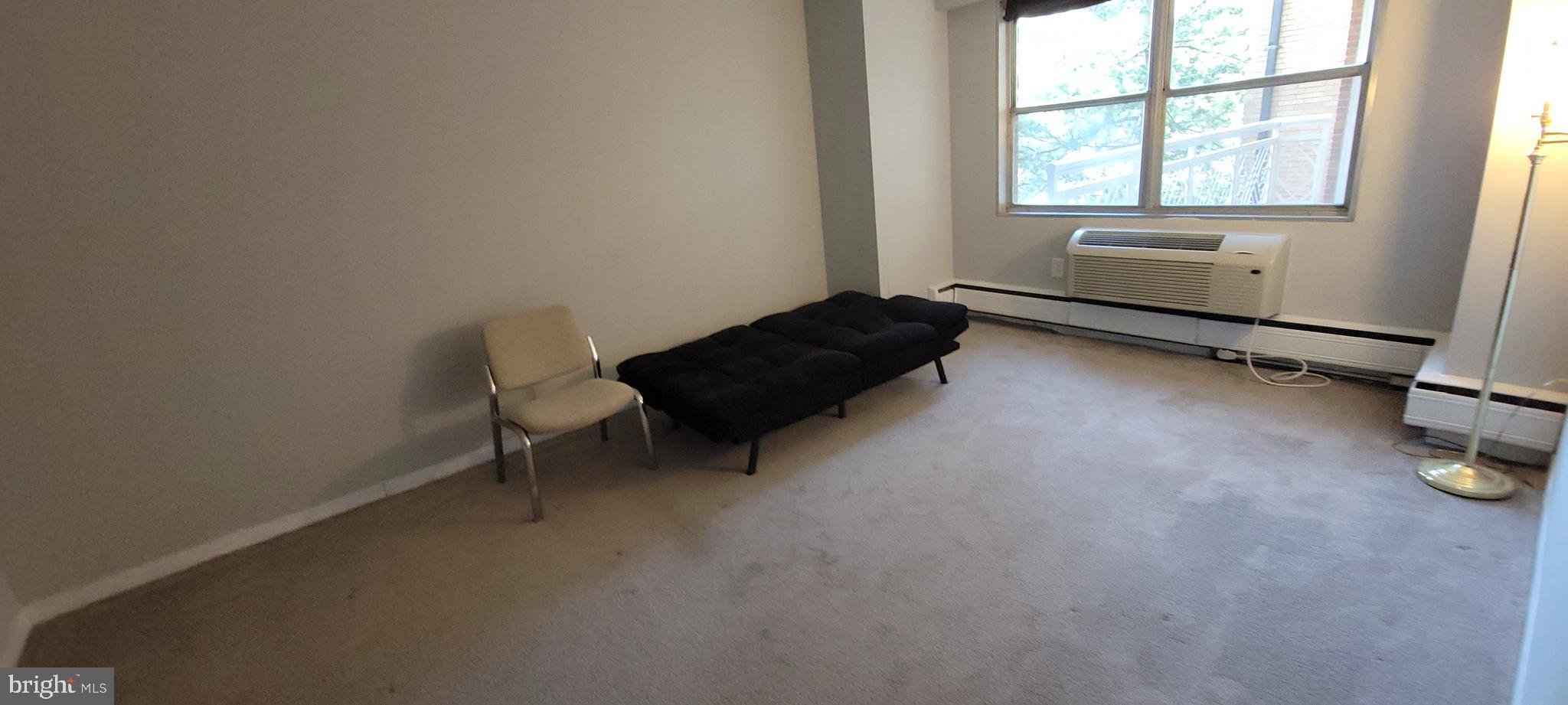 7900 Old York Road, Unit 505A Elkins Park, PA 19027 - Photo 9 of 12 a living room with furniture and a window