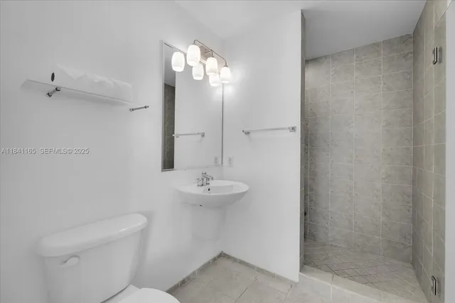 a bedroom with bed and wooden floor