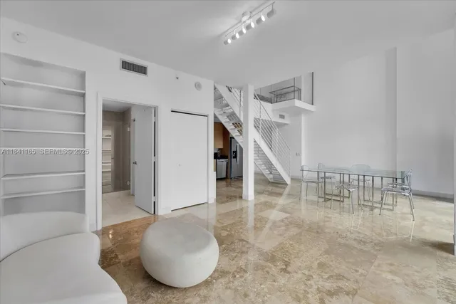 a kitchen with stainless steel appliances granite countertop a refrigerator sink and microwave