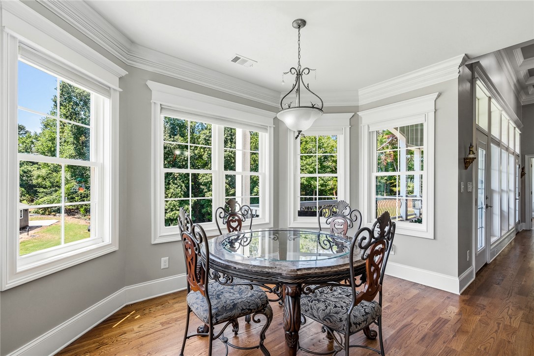 206 James Hare Road Anderson, SC 29626 - Photo 11 of 50 A graceful dining area, sun-filled by bay windows, features rich hardwood floors and an elegant chandelier.