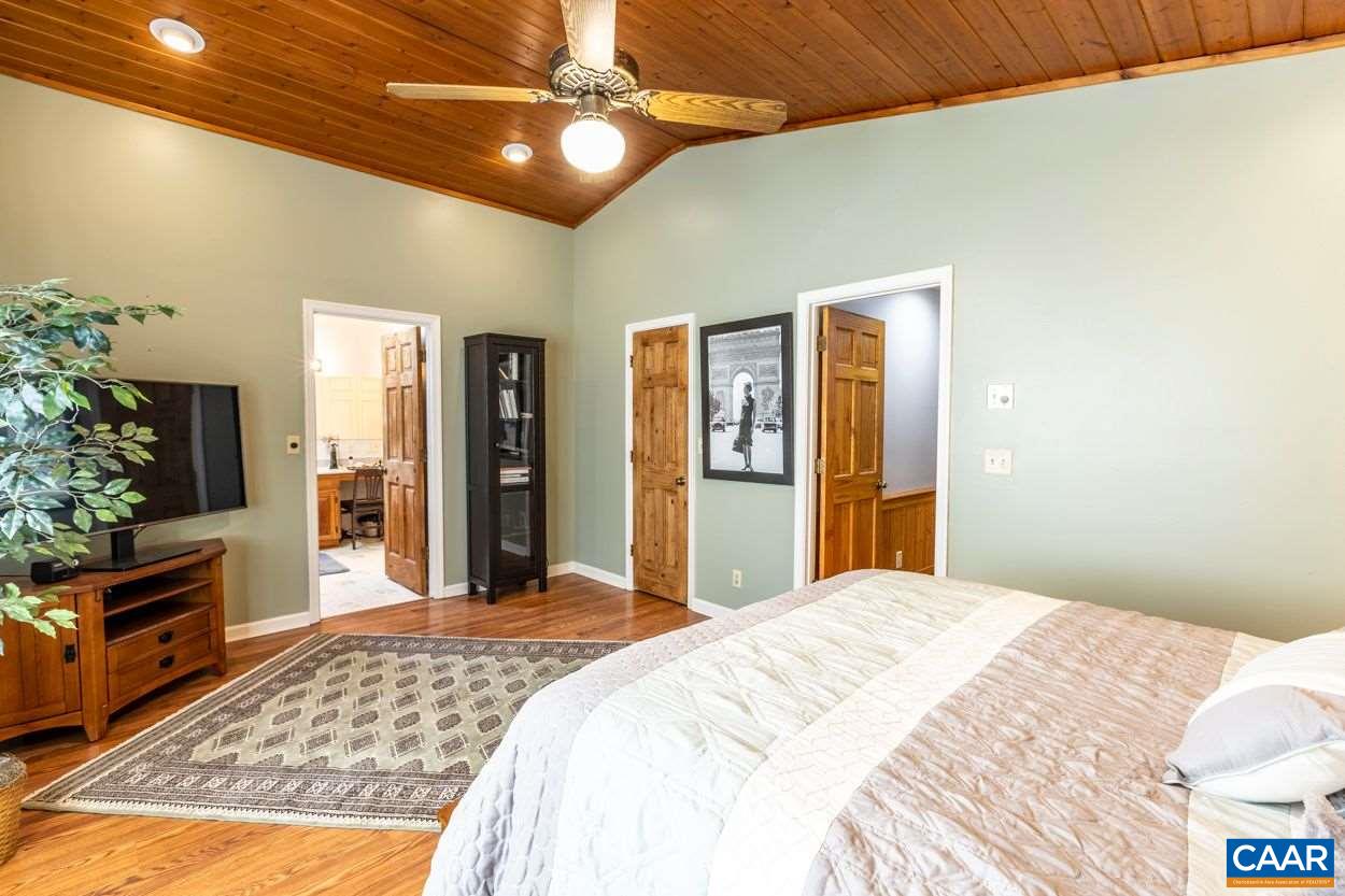 28 Colonial Road Palmyra, VA 22963 - Photo 19 of 40 a bedroom with a bed and a chandelier