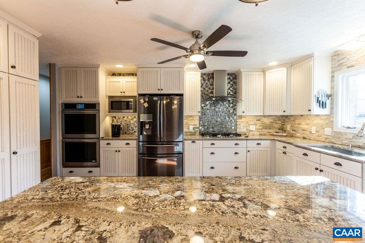 28 Colonial Road Palmyra, VA 22963 - Photo 2 of 40 a kitchen with refrigerator cabinets and stainless steel appliances