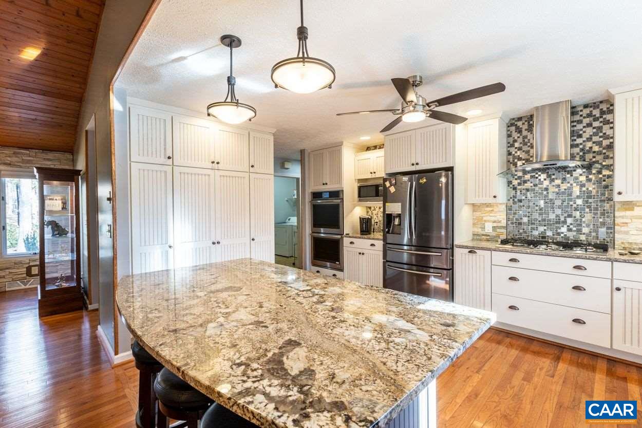 28 Colonial Road Palmyra, VA 22963 - Photo 5 of 40 a kitchen with stainless steel appliances kitchen island granite countertop a refrigerator and microwave