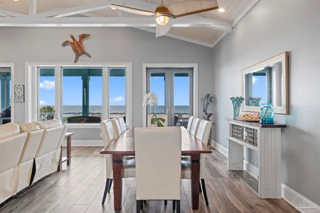 a dining room with wooden floor and furniture