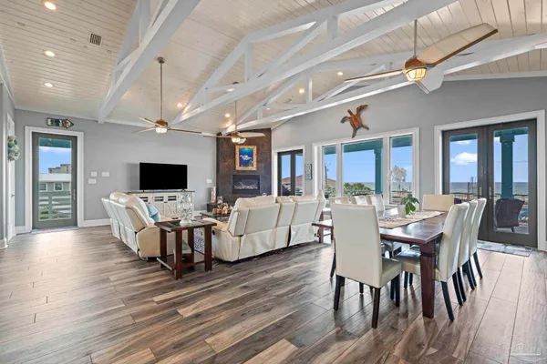 a dining room with wooden floor and furniture