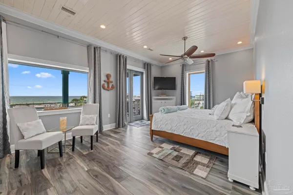 a bed room with furniture and a flat screen tv