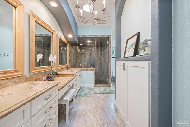 a bathroom with a granite countertop sink mirror and double
