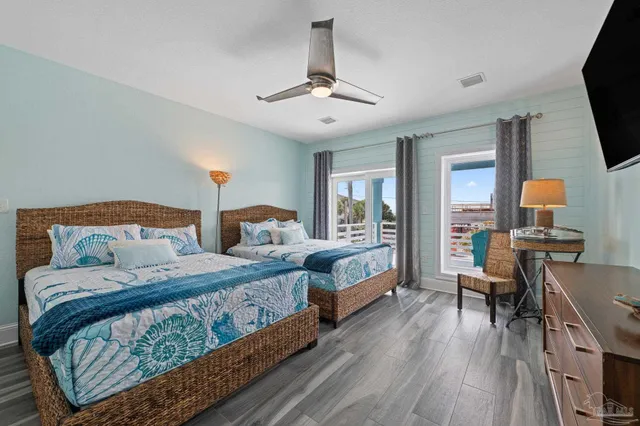 a view of a hallway with wooden floor and entryway