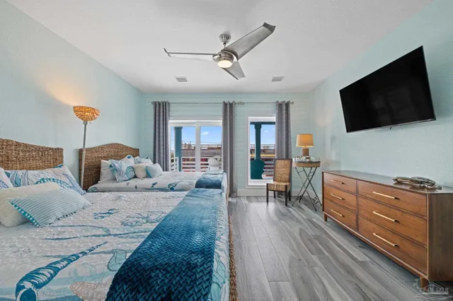 a bedroom with a bed and flat screen tv