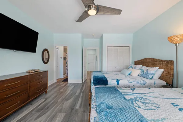 a bedroom with a bed and flat screen tv