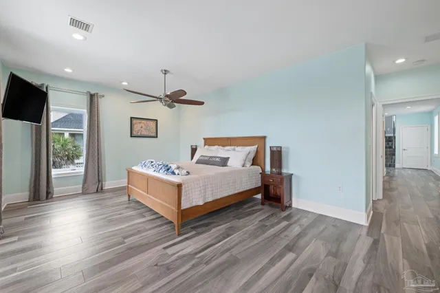 a large kitchen with stainless steel appliances granite countertop a large counter top and wooden floors