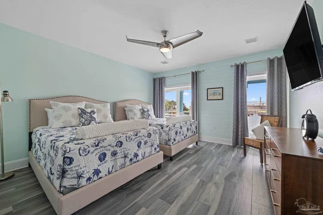 a living room with furniture a table and wooden floor
