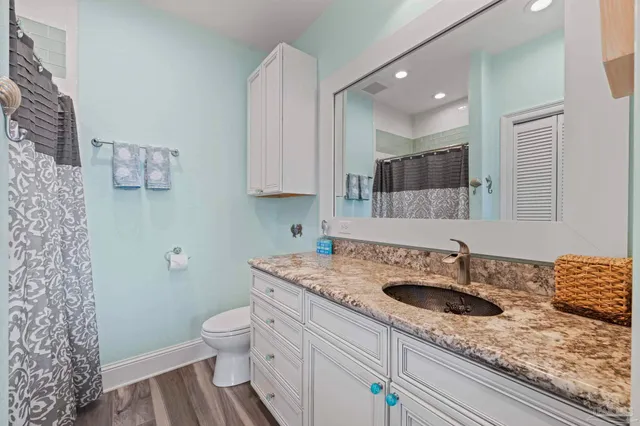 a living room with furniture a large window and wooden floor