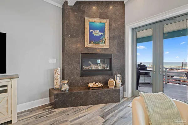 a living room with furniture a flat screen tv and a fireplace