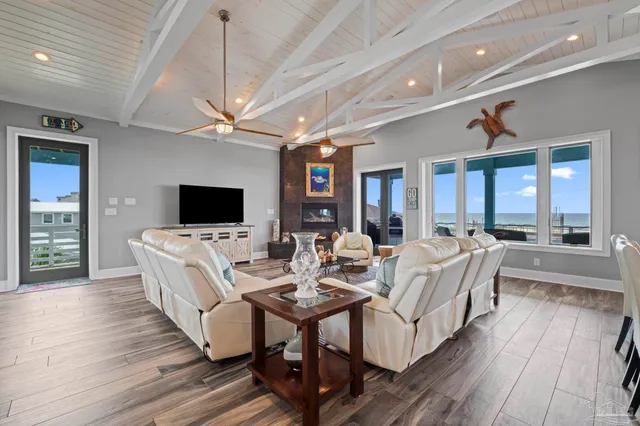 a living room with furniture a flat screen tv and a fireplace
