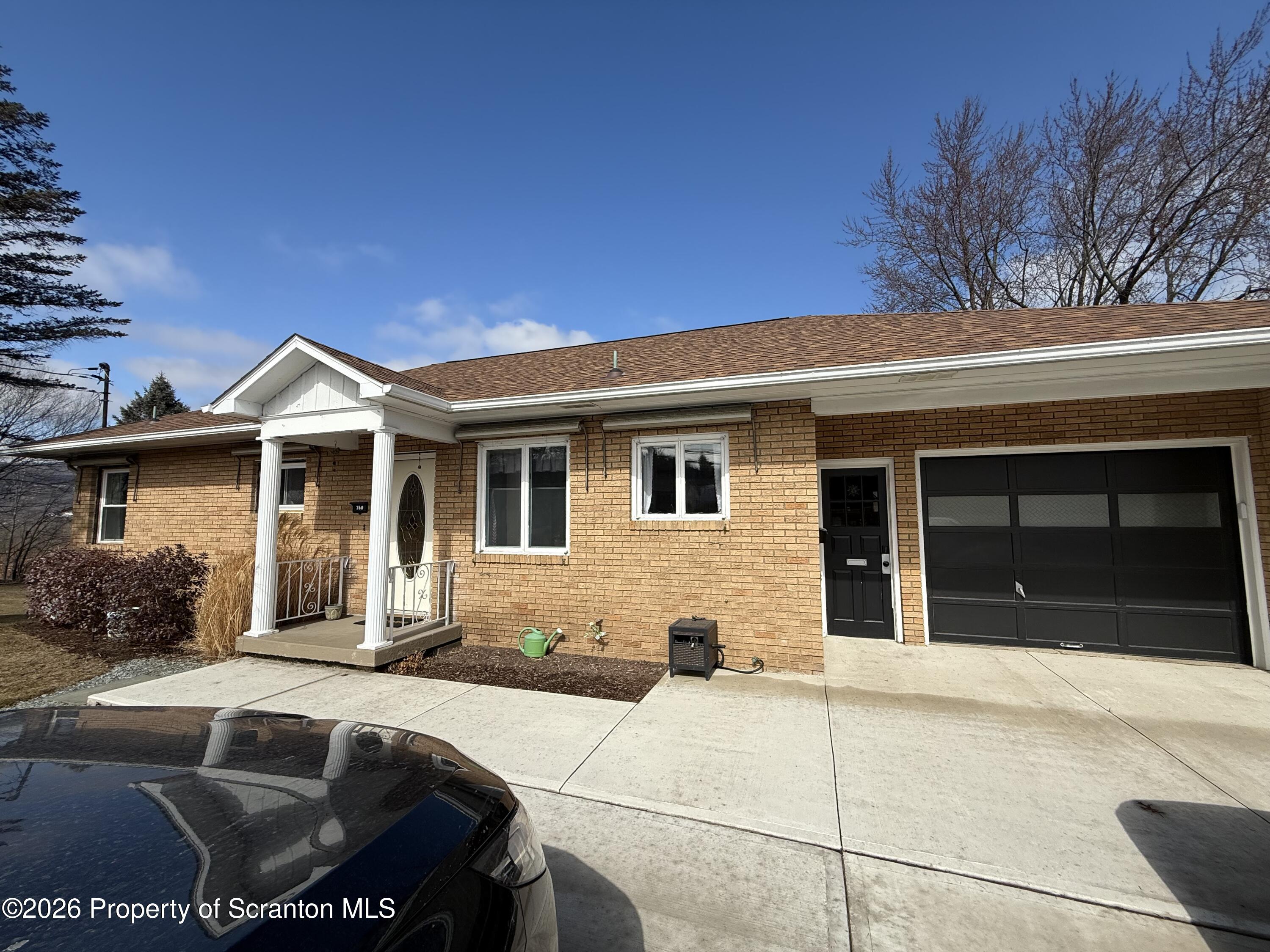 760 North Valley Avenue Olyphant, PA 18447 - Photo 1 of 34 a front view of a house with a yard and garage