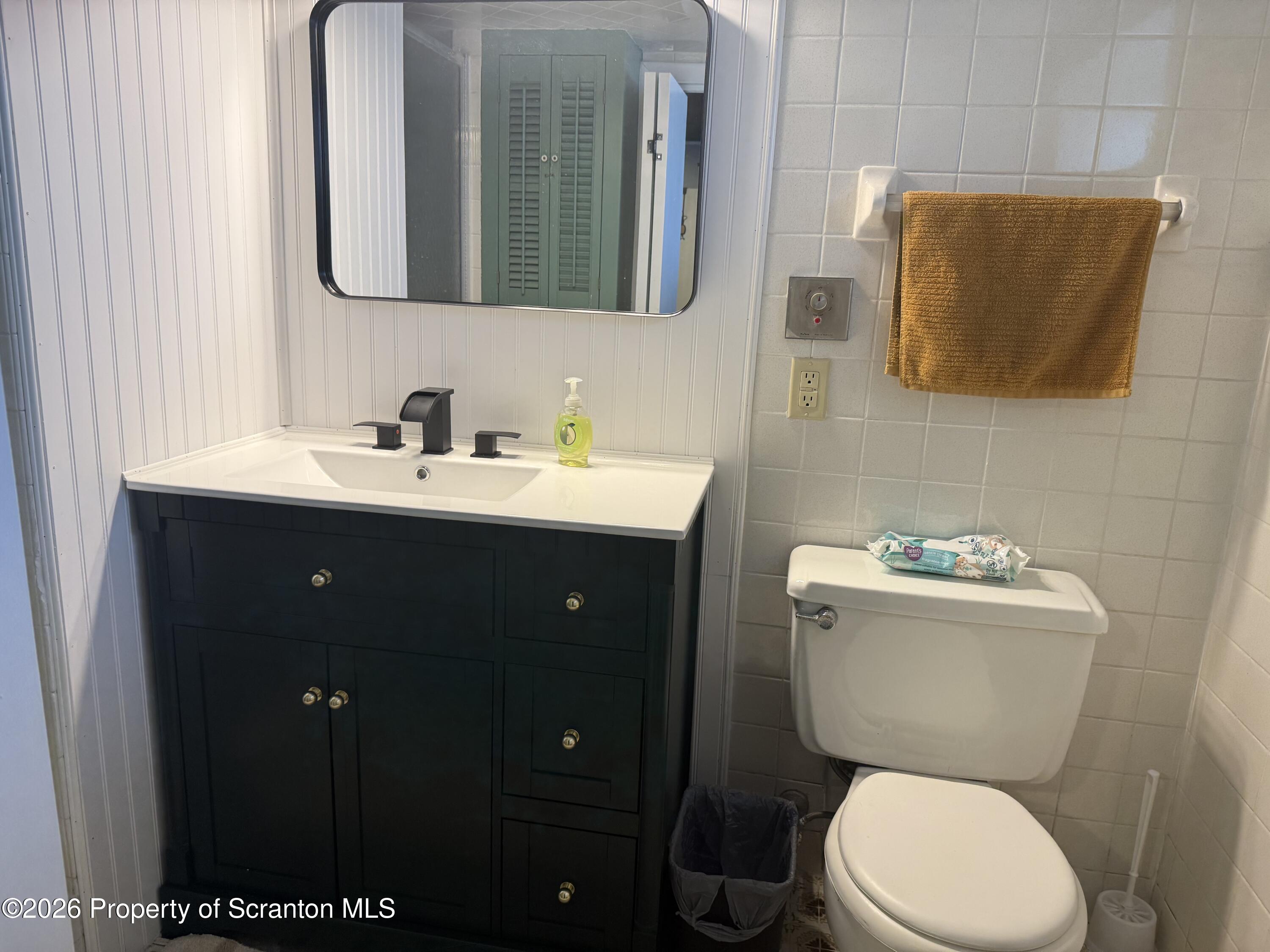 760 North Valley Avenue Olyphant, PA 18447 - Photo 15 of 34 a bathroom with a toilet sink vanity and mirror