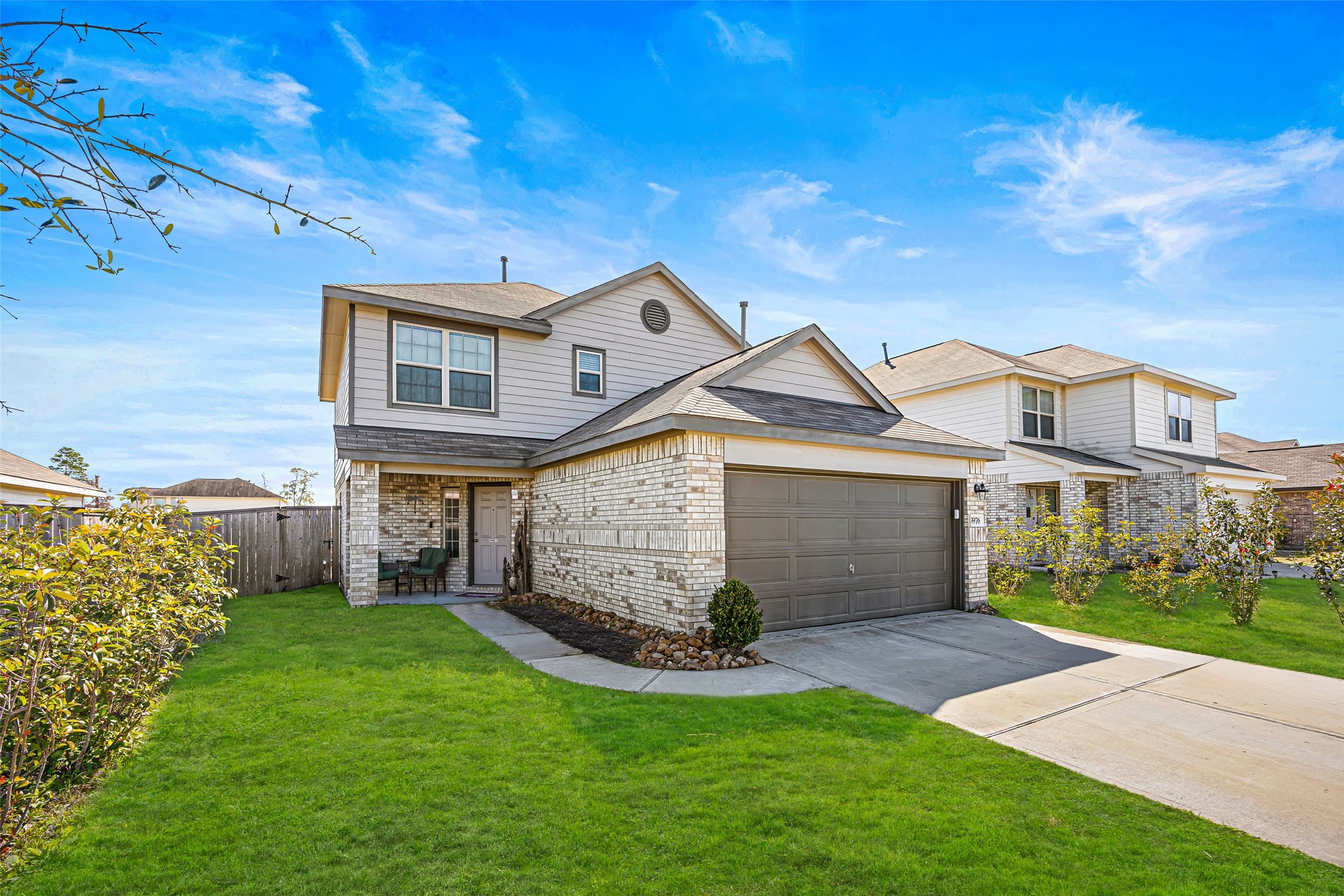 5976 Rimini Landing Lane Porter, TX 77365 - Photo 2 of 18 a front view of a house with a garden and yard
