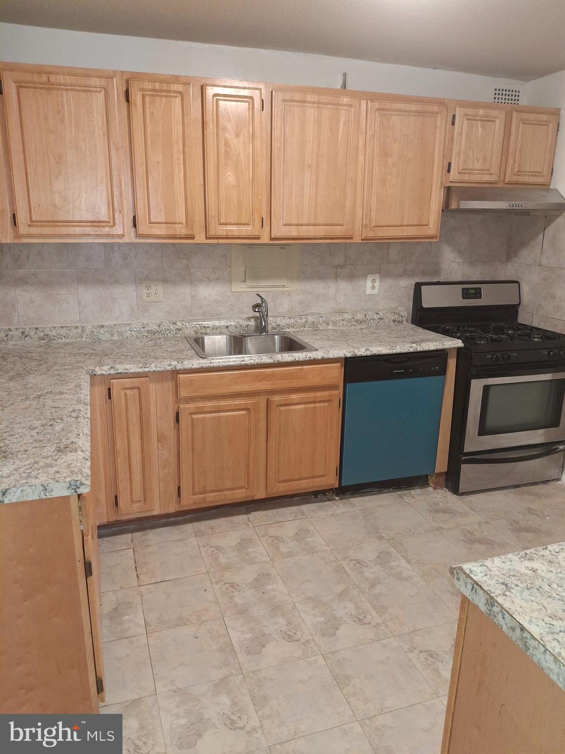 1836 Metzerott Road, Unit 222 Hyattsville, MD 20783 - Photo 1 of 9 a kitchen with granite countertop a sink stove and cabinets